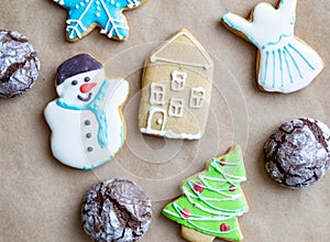 Gingerbread painted colored gingerbread cookies and spices and snowflakes on a craft background close-up. Christmas