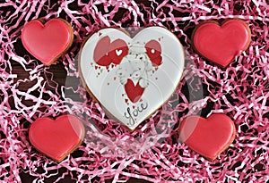 Gingerbread in the shape of a heart with a pink background, in a gift box.. Mom`s day. Valentine`s day.