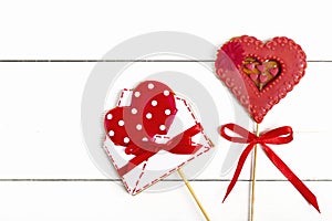 Gingerbread in shape of red heart and envelope for writing on white wooden background Happy Valentine`s day