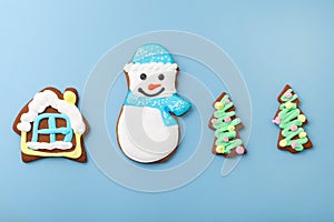 gingerbread snowman top view and house with christmas tree. different cookies on blue background