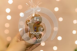 Gingerbread in a transparent bag, waves his hand. Gingerbread cookie in the shape of a man.
