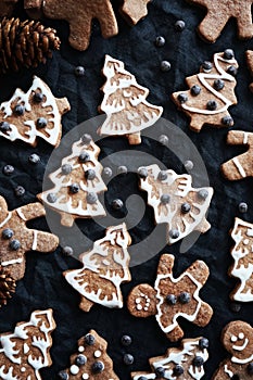 Gingerbread with white icing on a dark background