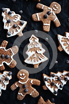Gingerbread with white icing on a dark background