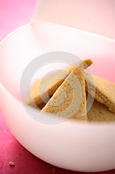 Gingerbreads in white plastic bowl