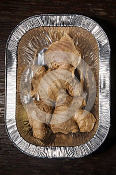 Gingerroot in aluminum foil, ginger fresh and raw photo