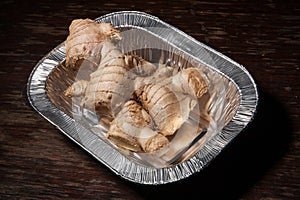 Gingerroot in aluminum foil, ginger fresh and raw photo