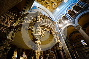 Giovanni Pisano`s marble pulpit highlights the interior of the Santa Maria Assunta, Pisa`s grand Duomo Cathedral in Pisa Italy photo