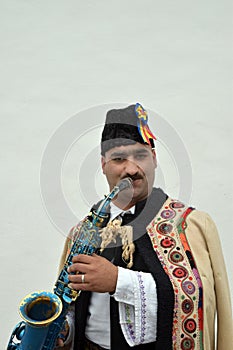 Gipsy singing traditional Romanian carols at saxophone.