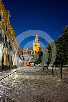 The Giralda bell tower lit up at night in Seville, Spain, Europe