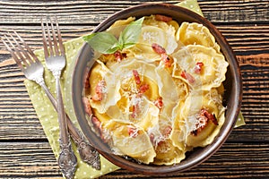 Girasoli sunflower shaped pasta with cheese, basil and bacon on plate. Horizontal top view photo