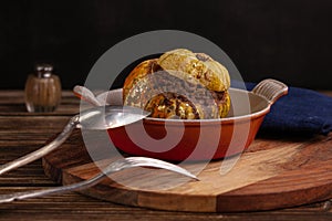 Giraumon or turbaned pumpkin stuffed with meat in an old dish photo