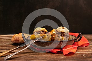 Giraumon or turbaned pumpkin stuffed with meat in an old dish photo