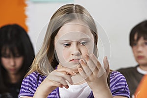 Girl (10-12) with Down syndrome in classroom