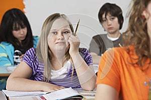 Girl (10-12) with Down syndrome in classroom