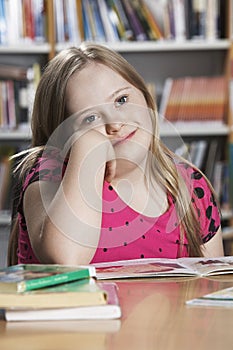 Girl (10-12) with Down syndrome in classroom