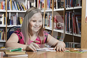 Girl (10-12) with Down syndrome in classroom