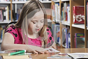 Girl (10-12) with Down syndrome in classroom