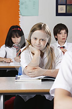 Girl (10-12) with Down syndrome in classroom