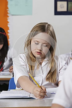 Girl (10-12) with Down syndrome in classroom