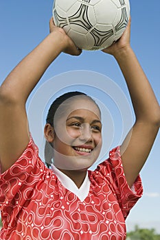 Girl (13-17) throwing in soccer ball