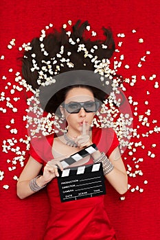 Girl with 3D Cinema Glasses, Popcorn and Director Clapboard Asking for Silence