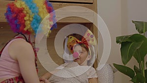 Girl of 7 years is visited by a female clown.