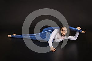 Girl acrobat, gymnastics, a young athlete in a blue and white suit , practicing acrobatics.  images on white background