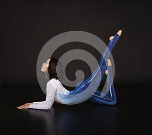 Girl acrobat, gymnastics, a young athlete in a blue and white suit , practicing acrobatics. Isolated images on white background