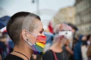 Girl activist wearing rainbow face mask during LGBT demonstration