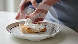 Girl Adding A Topping Whipped Cream On A Belgium Waffle