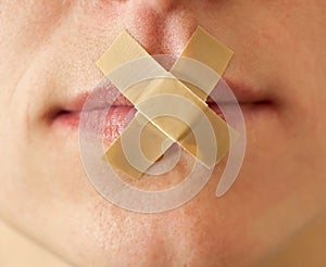 girl with an adhesive bandage her mouth.