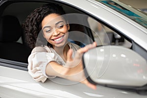Girl Adjusting Mirrors Sitting In Car In Dealership Showroom