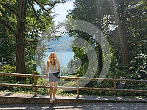 A girl admires Lake Como from the garden. photo