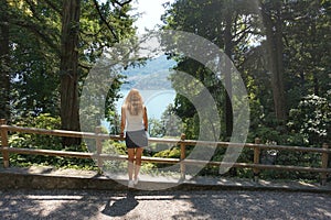 A girl admires Lake Como from the garden. photo