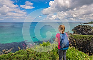 Girl admiring the Cornish coast