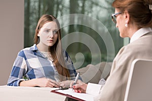 Girl in adolescence age on psychotherapy photo