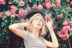 Girl adorable blonde sniffing fragrance of pink bloom. Spring and summer. Perfume and cosmetics. Woman in front of