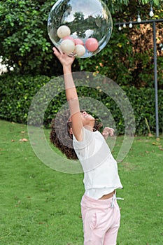 Girl with afro hair playing ball in the park