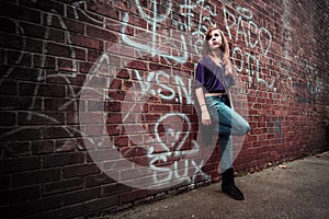 Girl against urban wall