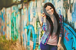 The girl against a wall with graffiti