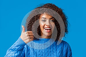 Girl agress with you. Close-up portrait cute african-american female with afro, curly haircut showing thumb-up in