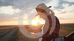 Girl agronomist with a smartphone analyzes the development of crops.