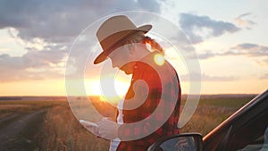 Girl agronomist with a smartphone analyzes the development of crops.