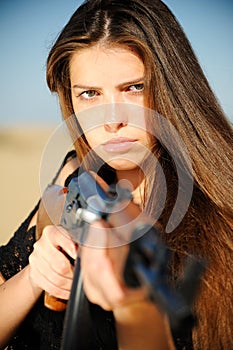 Girl aiming machine gun