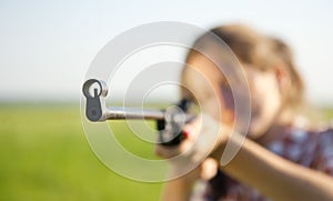 Girl aiming a pneumatic rifle