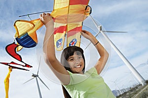 Girl With Airplane Kite At Wind Farm