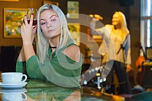 Girl with alcohol glass in pub club