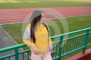 Girl alone in an empty stadium