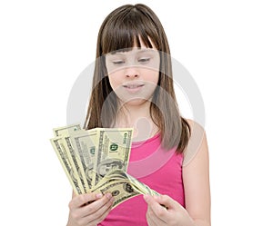 Girl in amazement holding money on white background