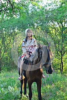 Girl in an ancient russian attire riding a horse